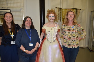 Actor dressed as Ada Lovelace stood with 3 adults