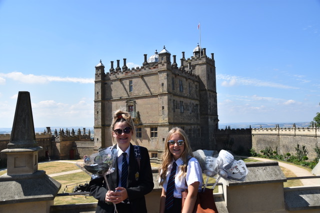 2 students sharing digital rose projects in front of Bolsover Castle
