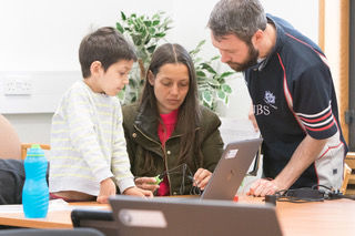 family 2 working around laptop