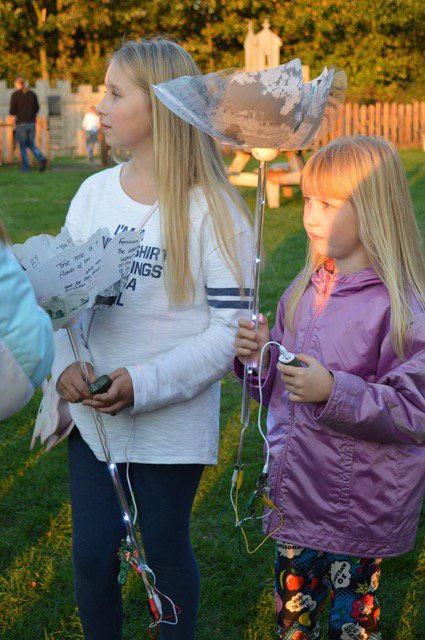 2 girls carrying digital rose projects