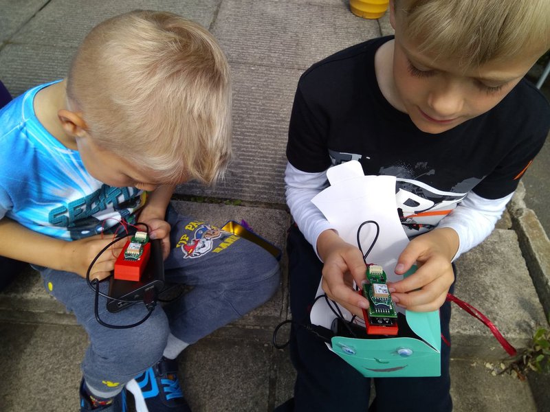 2 young boys showing their air quality projects