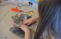 girl glueing acetate rose petals