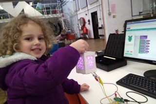 young child holding digital lantern project from manchester jam