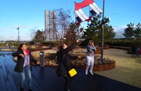 3 women launching a kite to fly