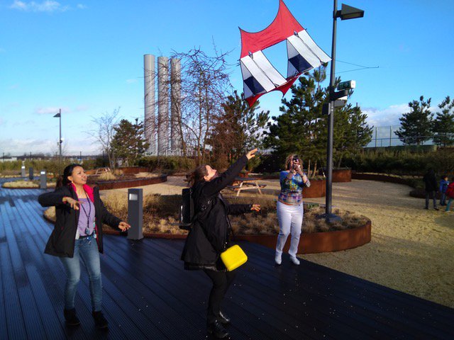 3 women launching a kite to fly