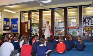 Actor performing as Ada Lovelace in front of a class of primary school children
